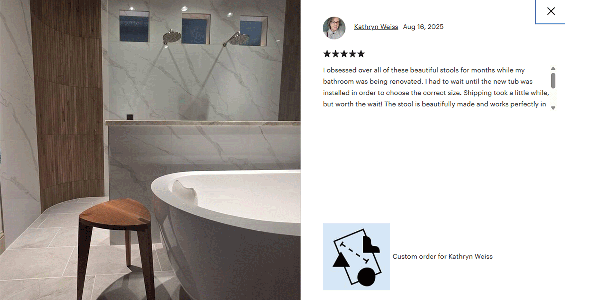 Bathroom with a freestanding bathtub and wooden stool, featuring a customer review on the right.